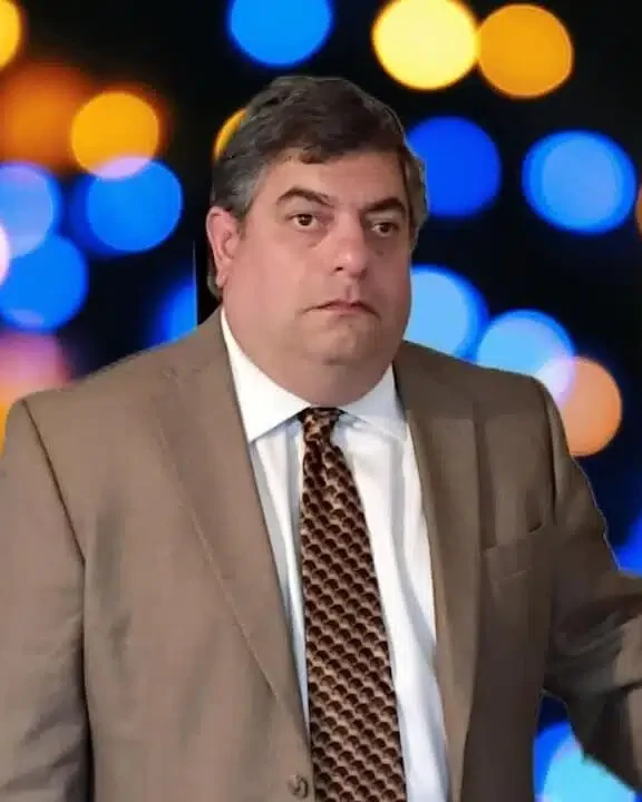 Edd Gimenez, CEO of Enthrone Capital, in a tan suit and patterned tie